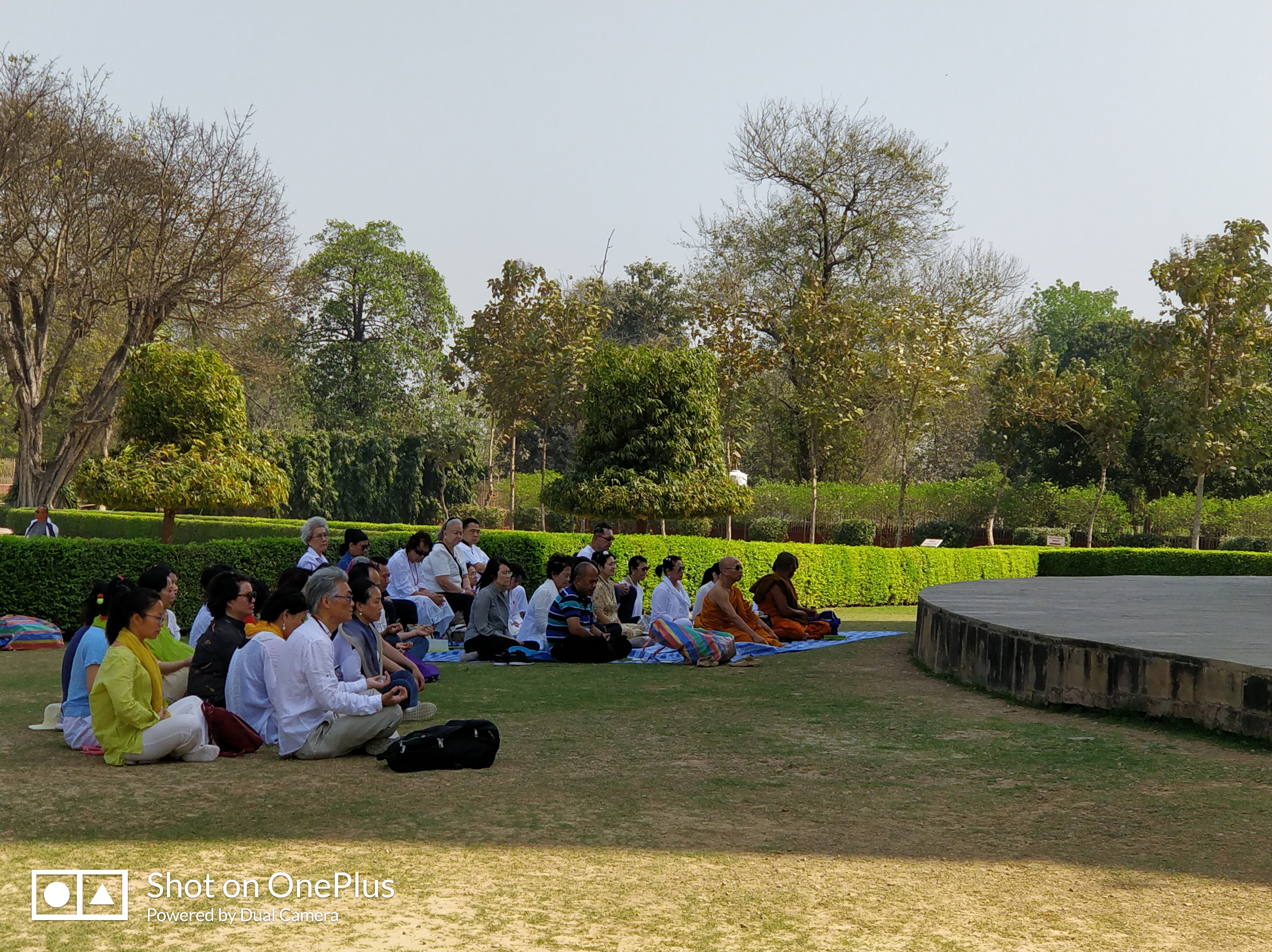 A group of Buddhist disciples praying at Dhameka Stupa